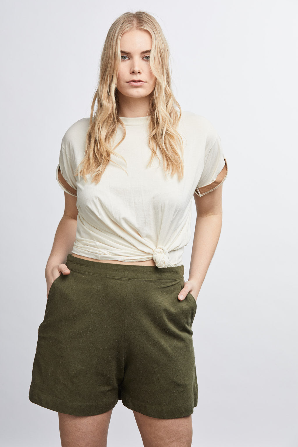 woman wearing green raw silk noil high waisted shorts and white tee shirt